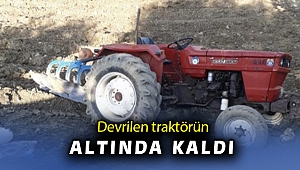 Devrilen traktörün altında sıkışan sürücüyü itfaiye kurtardı