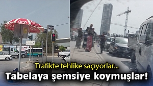 Trafikte tehlike saçıyorlar… Tabelaya şemsiye koymuşlar!