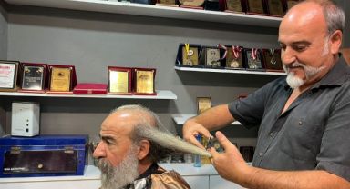 40 yıldır kesmediği saçlarını İranlı kadınlar için kesti